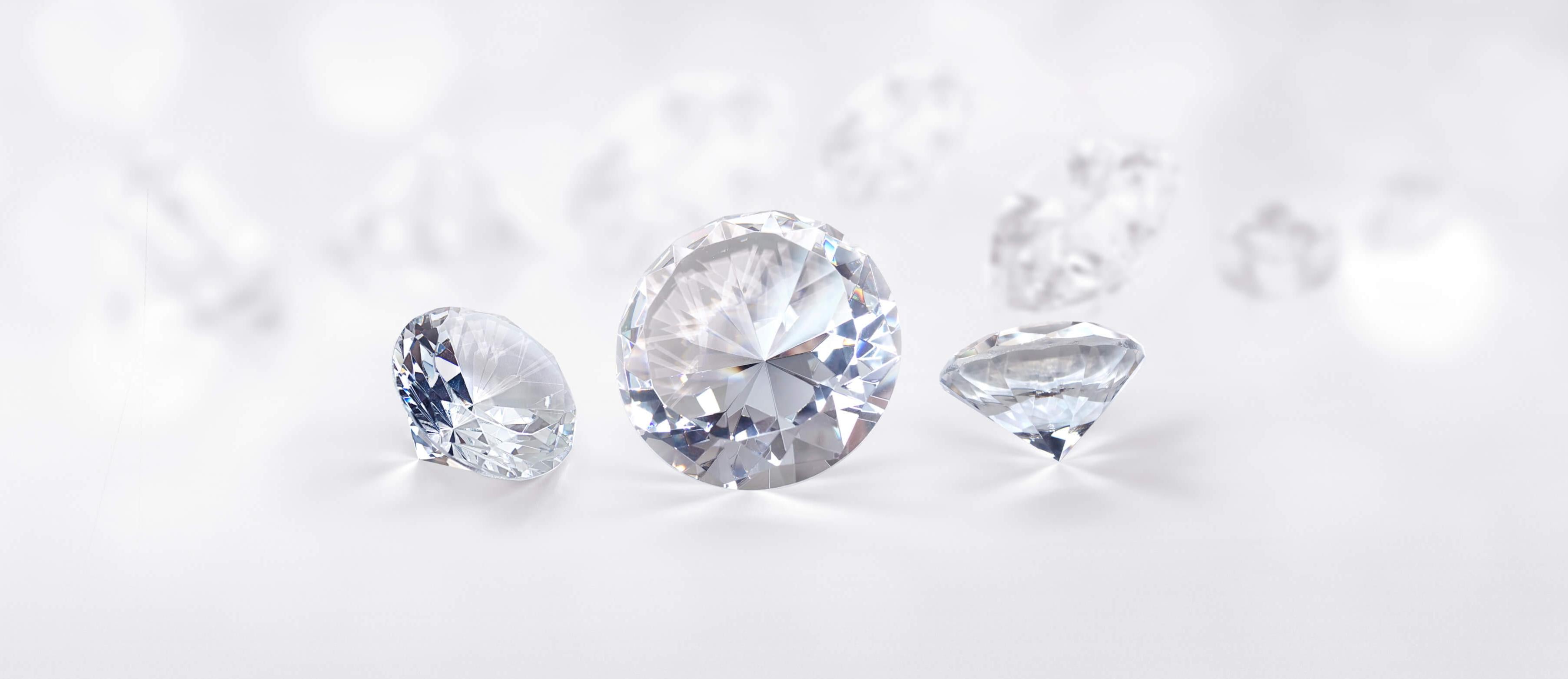 Three Moissanite diamonds on a white background